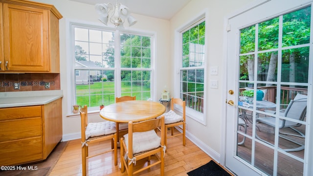 777 Marsh Rose Path NW, Calabash, NC 28467 - dining area with a chandelier, baseboards, and light wood-type flooring