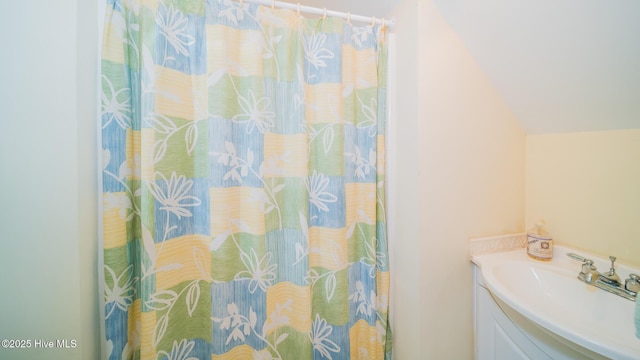 777 Marsh Rose Path NW, Calabash, NC 28467 - bathroom featuring vanity, vaulted ceiling, and curtained shower