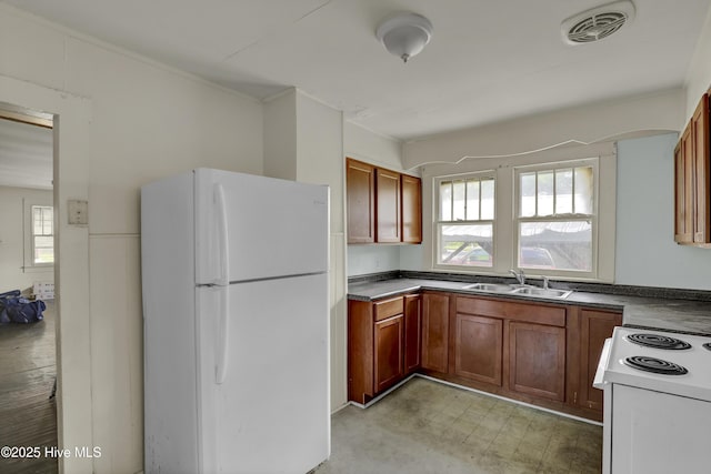 222 Evans St, Wilmington, NC 28405 - kitchen with white appliances, dark countertops, and light flooring