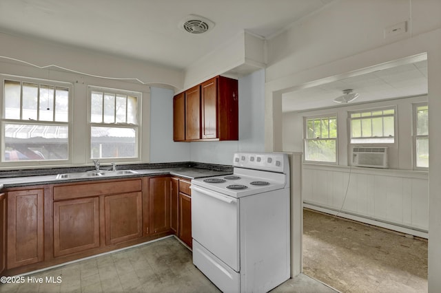 222 Evans St, Wilmington, NC 28405 - kitchen featuring white electric stove, baseboard heating, dark countertops, brown cabinets, and light flooring