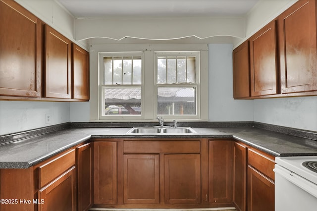 222 Evans St, Wilmington, NC 28405 - kitchen with dark countertops, brown cabinets, and white electric range oven