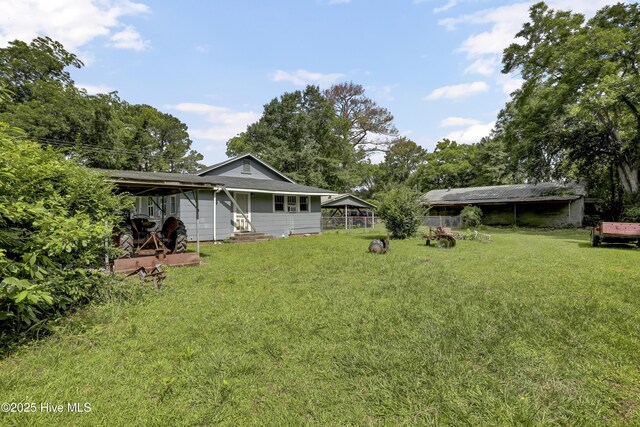 222 Evans St, Wilmington, NC 28405 - view of green lawn featuring a carport