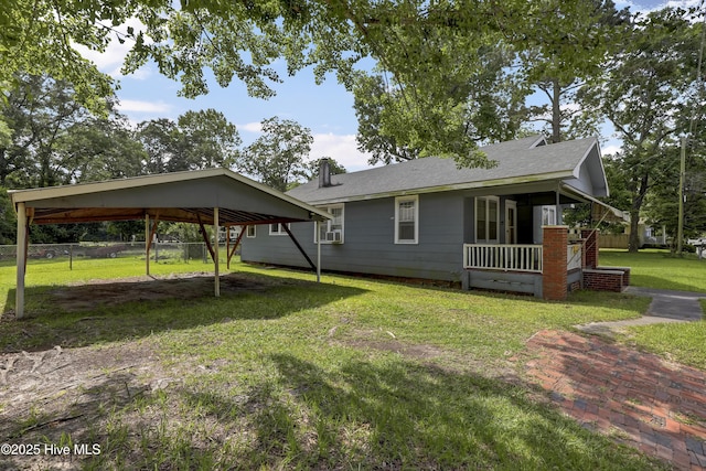 222 Evans St, Wilmington, NC 28405 - view of side of home featuring a detached carport, a chimney, and roof with shingles