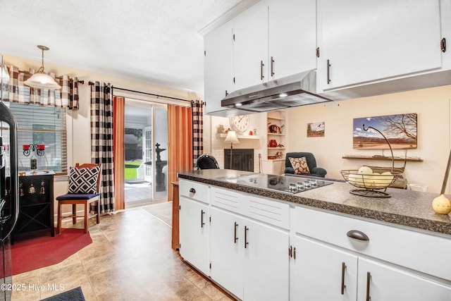 2305 Hardee Rd, Kinston, NC 28504 - kitchen with under cabinet range hood, electric stovetop, dark countertops, white cabinetry, and a textured ceiling