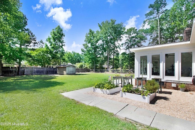 2305 Hardee Rd, Kinston, NC 28504 - fenced backyard featuring a vegetable garden and a storage shed