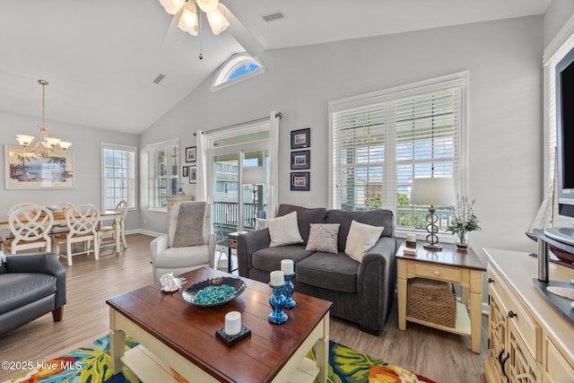 3725 Island Dr, North Topsail Beach, NC 28460 - living room with wood finished floors, a chandelier, ceiling fan, and high vaulted ceiling
