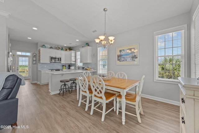 3725 Island Dr, North Topsail Beach, NC 28460 - dining area featuring a chandelier, light wood-style floors, baseboards, recessed lighting, and lofted ceiling