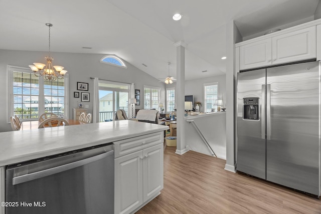 3725 Island Dr, North Topsail Beach, NC 28460 - kitchen with appliances with stainless steel finishes, vaulted ceiling, light wood finished floors, a chandelier, and white cabinetry