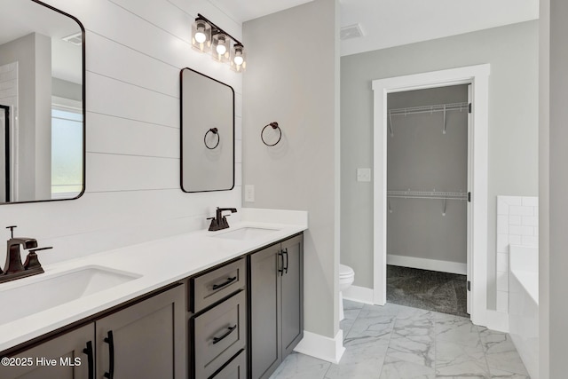 4037 Fulford Mcmillan Rd, Raeford, NC 28376 - full bath with marble finish floors, toilet, double vanity, baseboards, and a garden tub