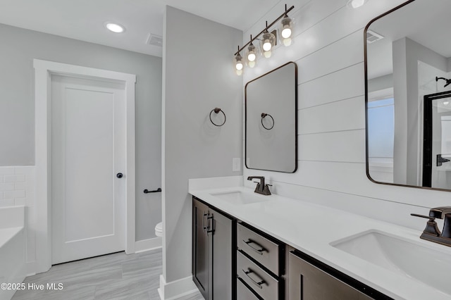 4037 Fulford Mcmillan Rd, Raeford, NC 28376 - bathroom featuring double vanity, toilet, baseboards, a bath, and a shower