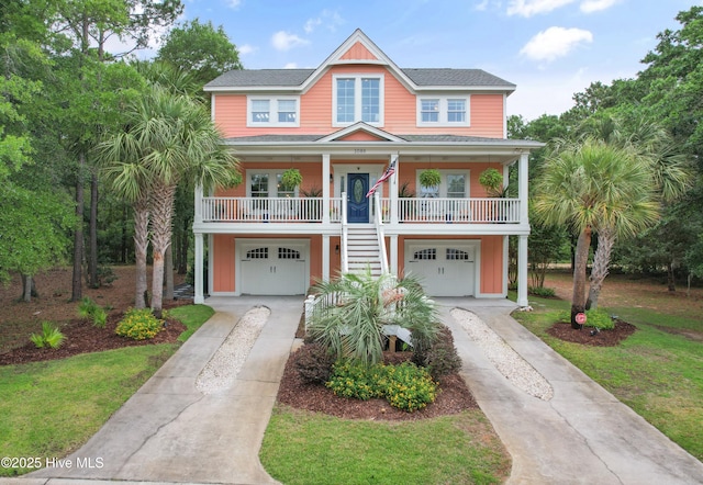 1086 Ferry Landing Dr SW, Supply, NC 28462 - raised beach house with driveway, an attached garage, stairway, a porch, and roof with shingles
