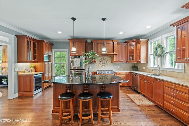 1086 Ferry Landing Dr SW, Supply, NC 28462 - kitchen featuring a sink, beverage cooler, crown molding, appliances with stainless steel finishes, and brown cabinetry