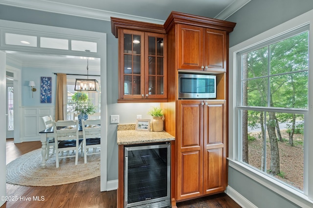 1086 Ferry Landing Dr SW, Supply, NC 28462 - kitchen with beverage cooler, stainless steel microwave, crown molding, glass insert cabinets, and plenty of natural light