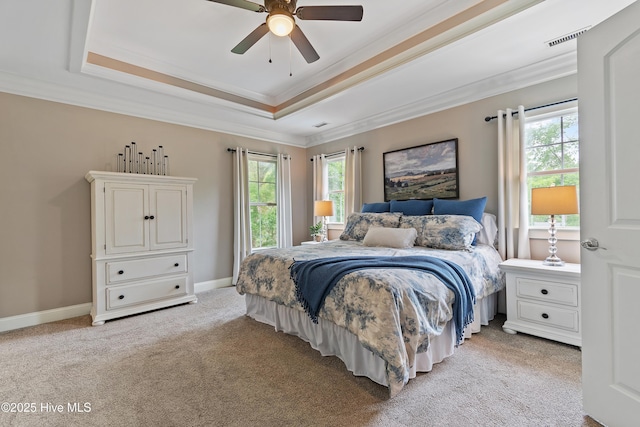 1086 Ferry Landing Dr SW, Supply, NC 28462 - bedroom featuring a raised ceiling, multiple windows, light carpet, crown molding, and a ceiling fan
