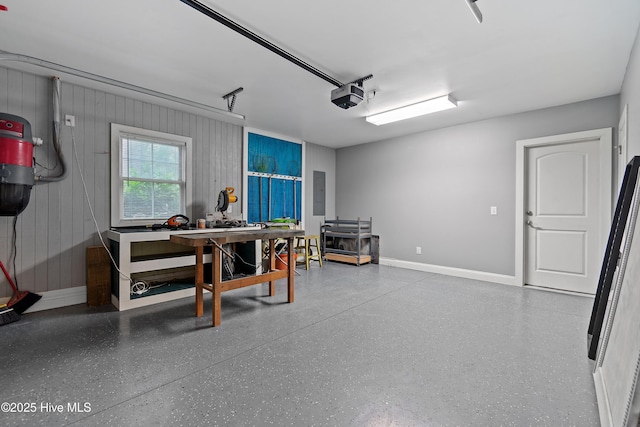 1086 Ferry Landing Dr SW, Supply, NC 28462 - garage featuring a garage door opener, baseboards, electric panel, a desk, and a central vacuum unit