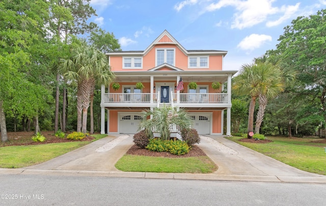 1086 Ferry Landing Dr SW, Supply, NC 28462 - coastal home with a garage, concrete driveway, covered porch, and a front lawn