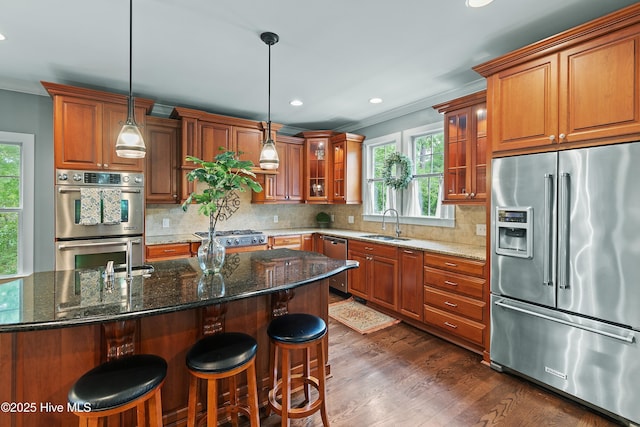 1086 Ferry Landing Dr SW, Supply, NC 28462 - kitchen with stainless steel appliances, ornamental molding, brown cabinetry, plenty of natural light, and recessed lighting