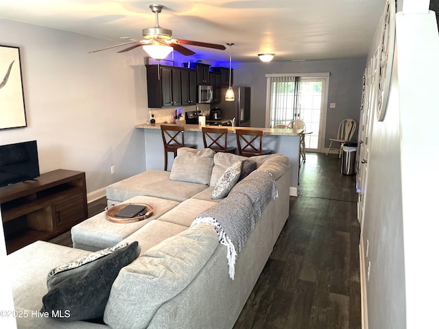 219 Grove Ln, Havelock, NC 28532 - living area featuring ceiling fan, dark wood-type flooring, and baseboards