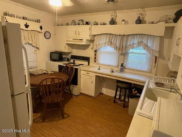 302 Lower St, Elizabethtown, NC 28337 - kitchen with white appliances, under cabinet range hood, crown molding, light wood-style flooring, and white cabinets