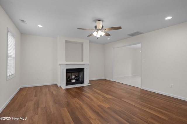 123 S Park Ln, Newport, NC 28570 - unfurnished living room with wood finished floors, a ceiling fan, a fireplace with flush hearth, baseboards, and recessed lighting