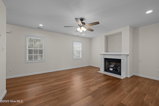 123 S Park Ln, Newport, NC 28570 - unfurnished living room with a fireplace with flush hearth, ceiling fan, wood finished floors, baseboards, and recessed lighting