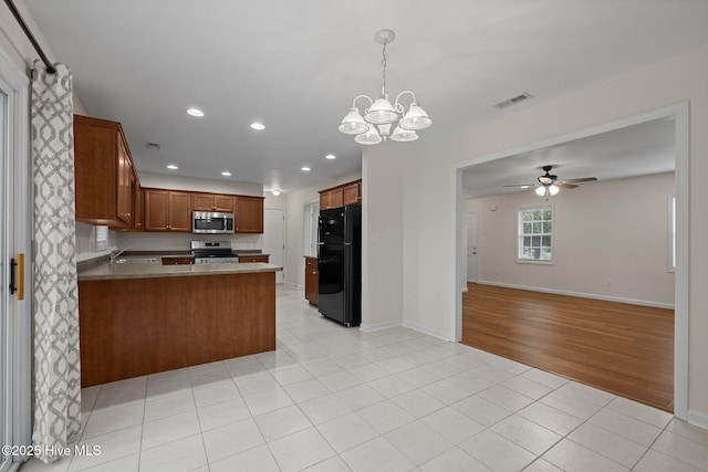 123 S Park Ln, Newport, NC 28570 - kitchen featuring appliances with stainless steel finishes, open floor plan, a chandelier, a peninsula, and recessed lighting