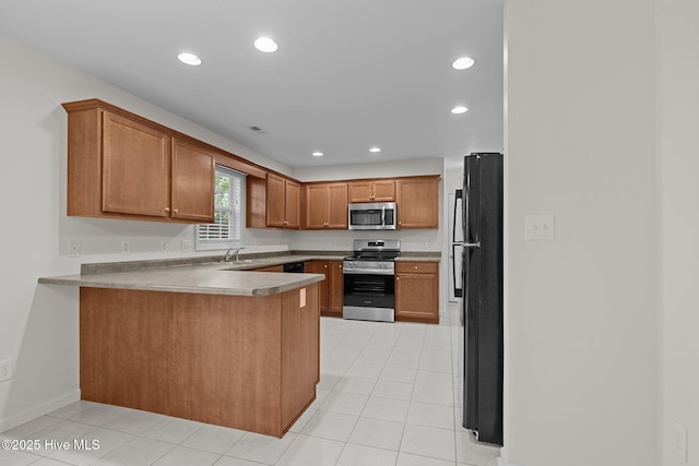 123 S Park Ln, Newport, NC 28570 - kitchen with stainless steel appliances, a peninsula, a sink, light tile patterned flooring, and recessed lighting