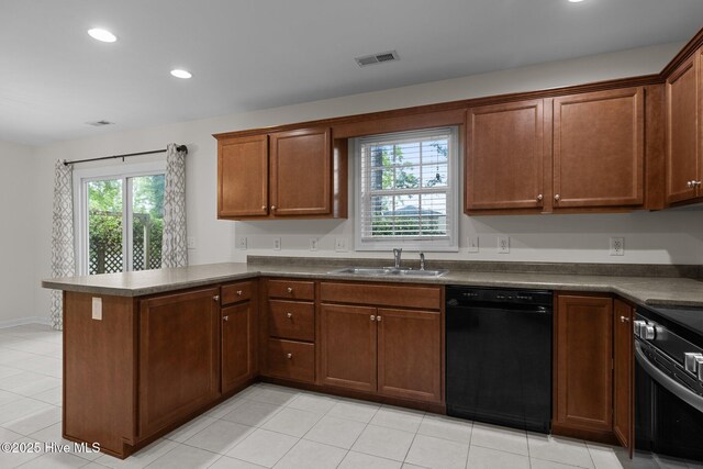 123 S Park Ln, Newport, NC 28570 - kitchen with black dishwasher, a sink, a peninsula, dark countertops, and stainless steel stove