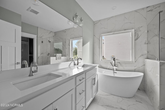 604 Willbrook Cir, Sneads Ferry, NC 28460 - bathroom featuring marble look tiles, double vanity, a marble finish shower, and a freestanding tub