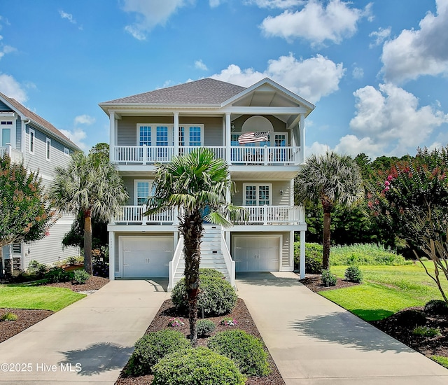 2820 Harborside Way, Southport, NC 28461 - beach home with a garage, a balcony, concrete driveway, covered porch, and stairs