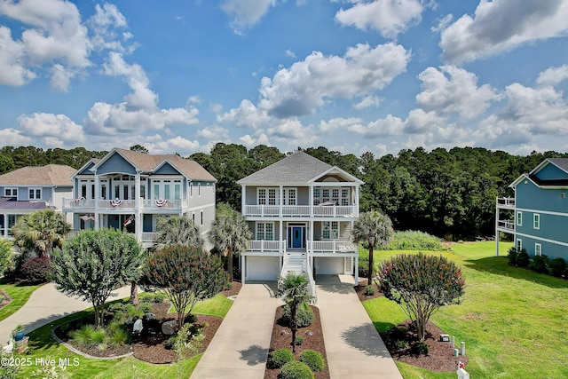 2820 Harborside Way, Southport, NC 28461 - raised beach house featuring a balcony, concrete driveway, a front yard, and an attached garage