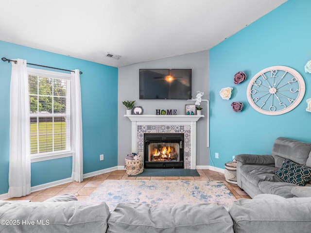 102 Sand Ct, Jacksonville, NC 28546 - living area featuring lofted ceiling, a tiled fireplace, baseboards, and tile patterned floors