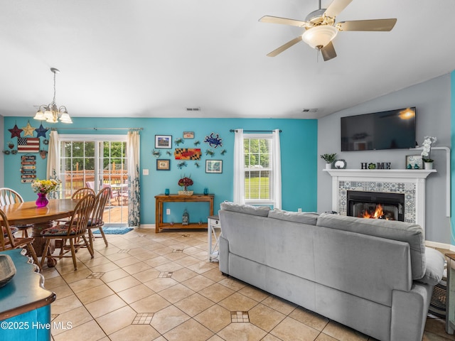 102 Sand Ct, Jacksonville, NC 28546 - living area with a chandelier, a tiled fireplace, ceiling fan, light tile patterned floors, and baseboards