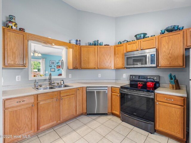 102 Sand Ct, Jacksonville, NC 28546 - kitchen featuring stainless steel appliances, a sink, light countertops, and light tile patterned floors