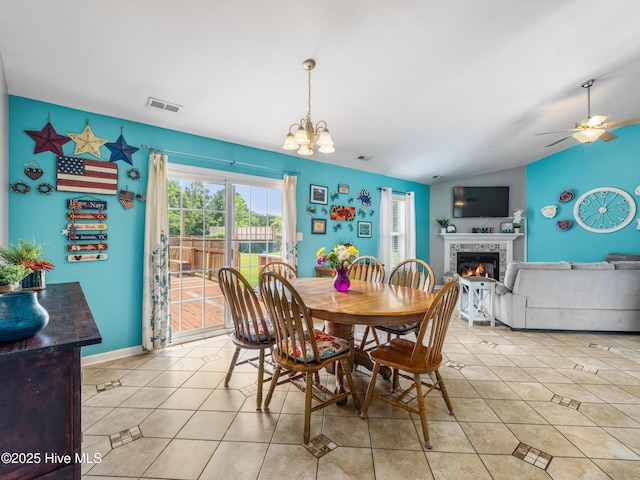102 Sand Ct, Jacksonville, NC 28546 - dining space featuring vaulted ceiling, a fireplace, light tile patterned floors, ceiling fan, and a chandelier