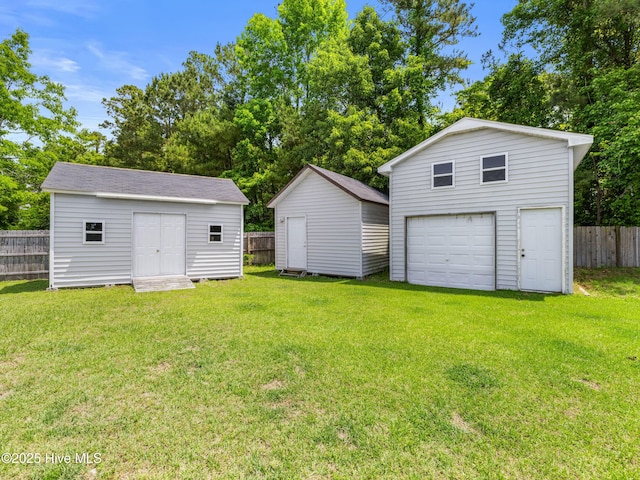 102 Sand Ct, Jacksonville, NC 28546 - view of yard featuring an outdoor structure, a detached garage, and driveway