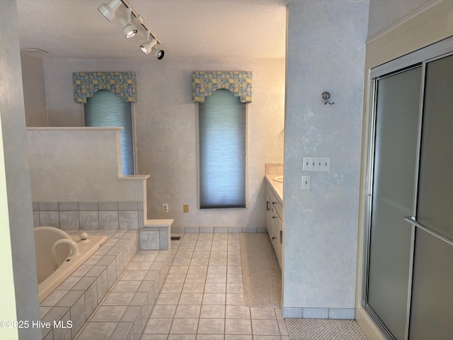 1608 Brices Creek Rd, New Bern, NC 28562 - bathroom featuring tile patterned floors, a garden tub, vanity, track lighting, and a shower with door