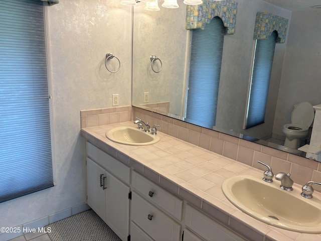 1608 Brices Creek Rd, New Bern, NC 28562 - full bath with double vanity, toilet, and tasteful backsplash