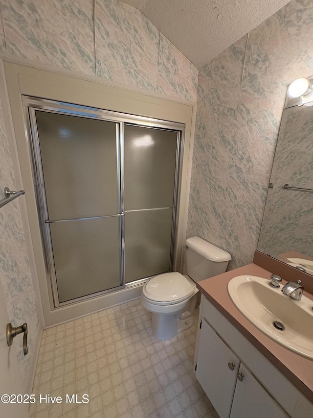 1608 Brices Creek Rd, New Bern, NC 28562 - full bathroom featuring wallpapered walls, vanity, a textured ceiling, an enclosed shower, and toilet