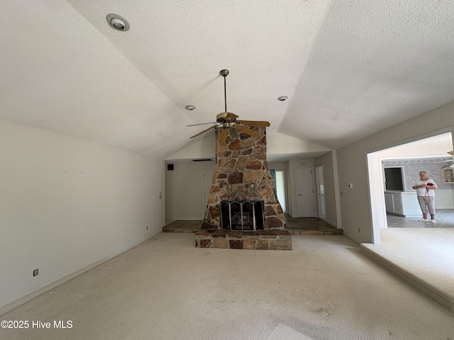 1608 Brices Creek Rd, New Bern, NC 28562 - unfurnished living room with a ceiling fan, carpet floors, lofted ceiling, a textured ceiling, and a fireplace
