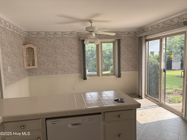 1608 Brices Creek Rd, New Bern, NC 28562 - kitchen with dishwasher, tile countertops, a ceiling fan, tile patterned floors, and wallpapered walls