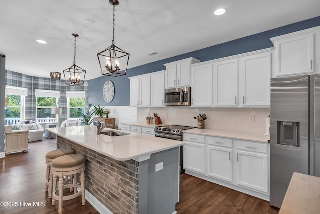1700 Sun Palms Blvd SE, Bolivia, NC 28422 - kitchen with stainless steel appliances, a sink, a chandelier, dark wood-style flooring, and recessed lighting