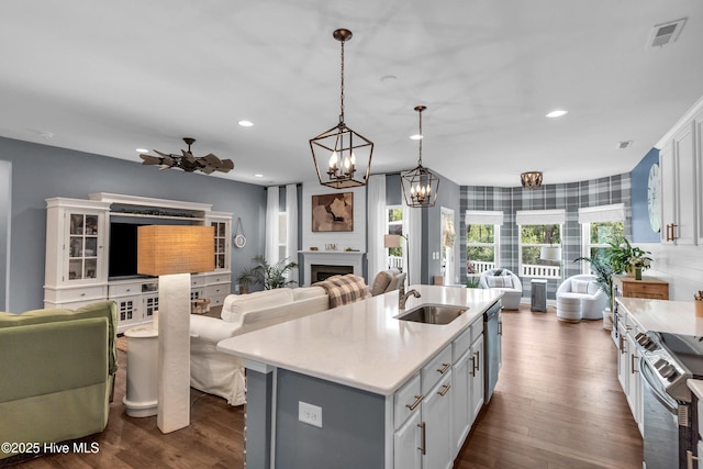 1700 Sun Palms Blvd SE, Bolivia, NC 28422 - kitchen featuring open floor plan, a sink, stainless steel appliances, dark wood-style floors, and light countertops
