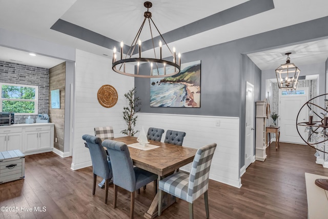 1700 Sun Palms Blvd SE, Bolivia, NC 28422 - dining area featuring a chandelier, dark wood finished floors, a tray ceiling, and baseboards