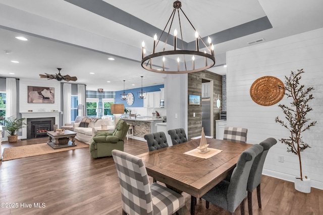 1700 Sun Palms Blvd SE, Bolivia, NC 28422 - dining space featuring a chandelier, healthy amount of natural light, dark wood finished floors, a lit fireplace, and recessed lighting