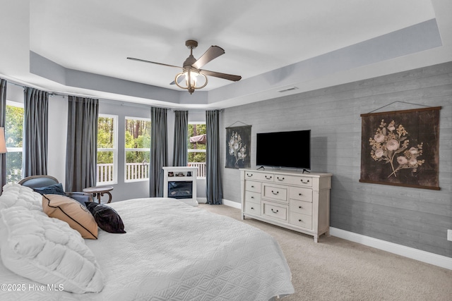 1700 Sun Palms Blvd SE, Bolivia, NC 28422 - bedroom featuring light carpet, baseboards, ceiling fan, and a raised ceiling