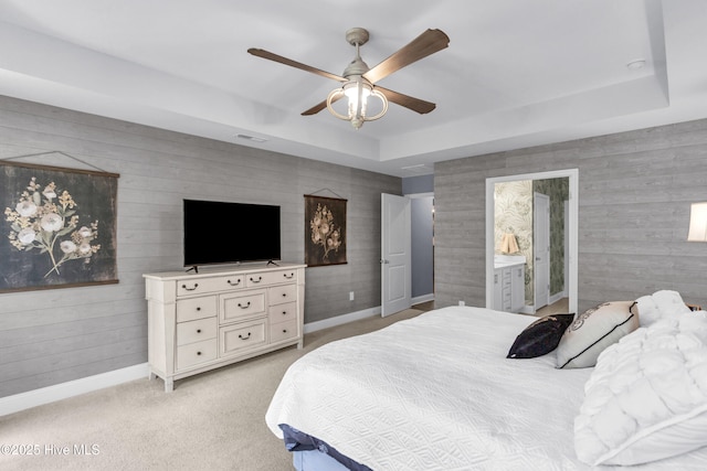 1700 Sun Palms Blvd SE, Bolivia, NC 28422 - bedroom with baseboards, a tray ceiling, light carpet, wooden walls, and ceiling fan