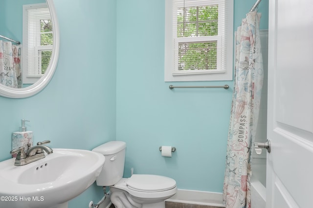 1858 E Boiling Spring Rd, Southport, NC 28461 - full bathroom with a sink, toilet, baseboards, and shower / bath combo with shower curtain