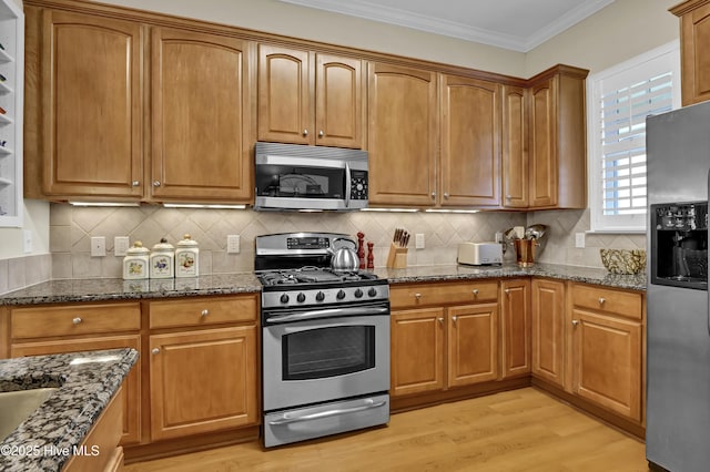 644 Village Park Dr Unit 207, Wilmington, NC 28405 - kitchen featuring appliances with stainless steel finishes, light wood-type flooring, brown cabinets, and crown molding