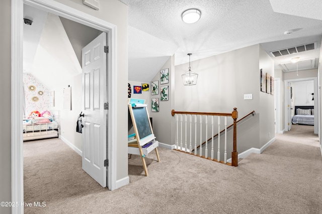 105 Teal Pointe Dr, Pikeville, NC 27863 - corridor featuring an upstairs landing, attic access, carpet, baseboards, and a textured ceiling